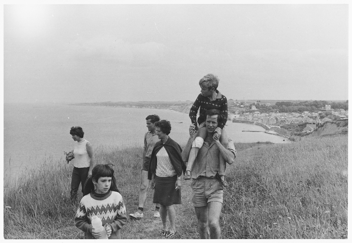 L-R Margaret Bearman (neé Roberts), Penny Bearman, Ken Roberts, Elsie Roberts, David Roberts with Jonathan Bearman on shoulders in France (knee in bandage having it open chasing Penny around caravan – as I remember it), 1967